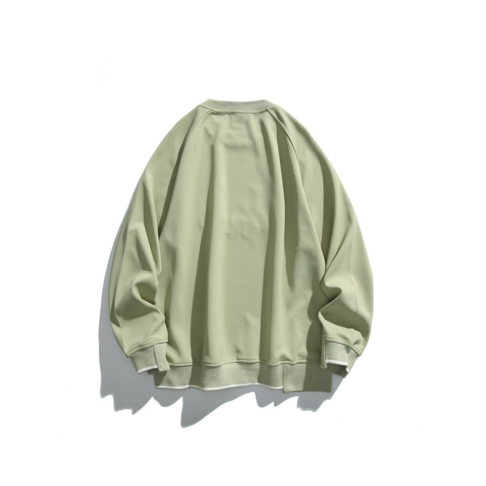Back of a pale sage-green crewneck sweatshirt with raglan sleeves and matching ribbed cuffs and hem.