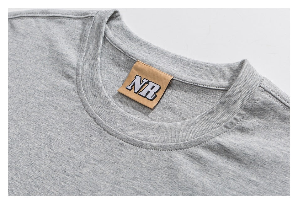 Close-up of a heather-gray T-shirt crew neck and tan NR neck label.