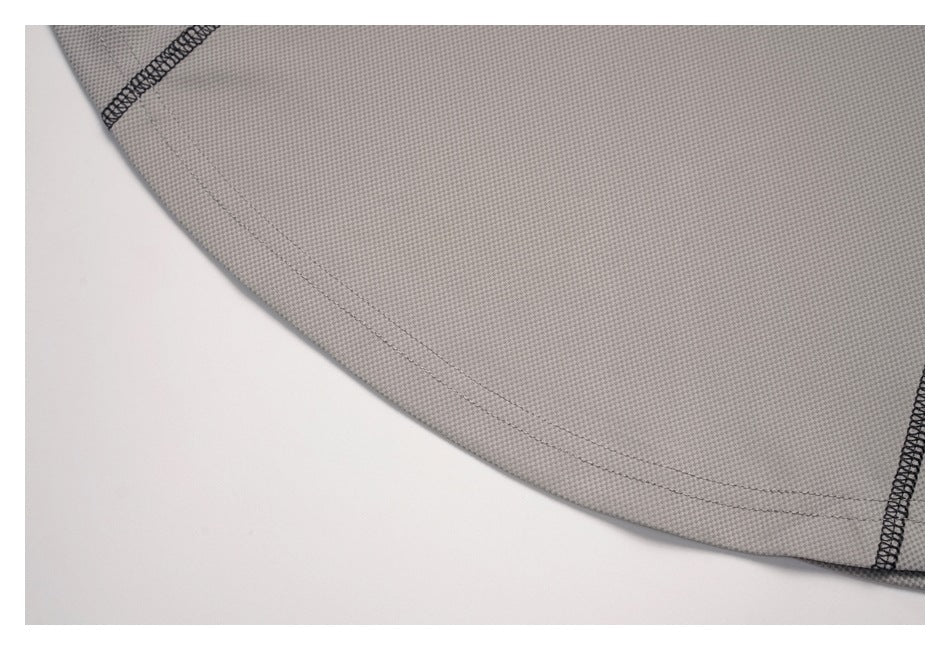 Close-up of the gray top's curved hem with double-row stitching.