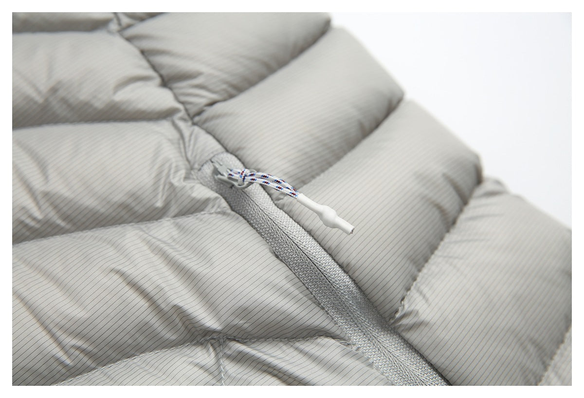 Close-up of a white-tipped braided zipper pull on the light gray pinstriped jacket.