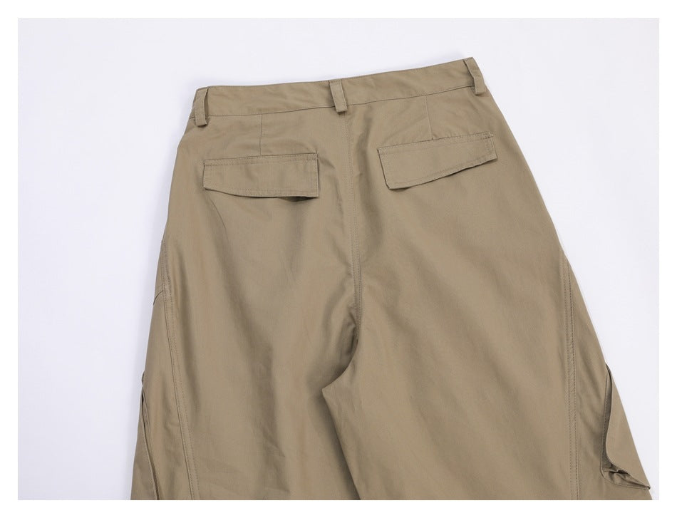 Back view of taupe trousers laid flat, with belt loops and two flap pockets.