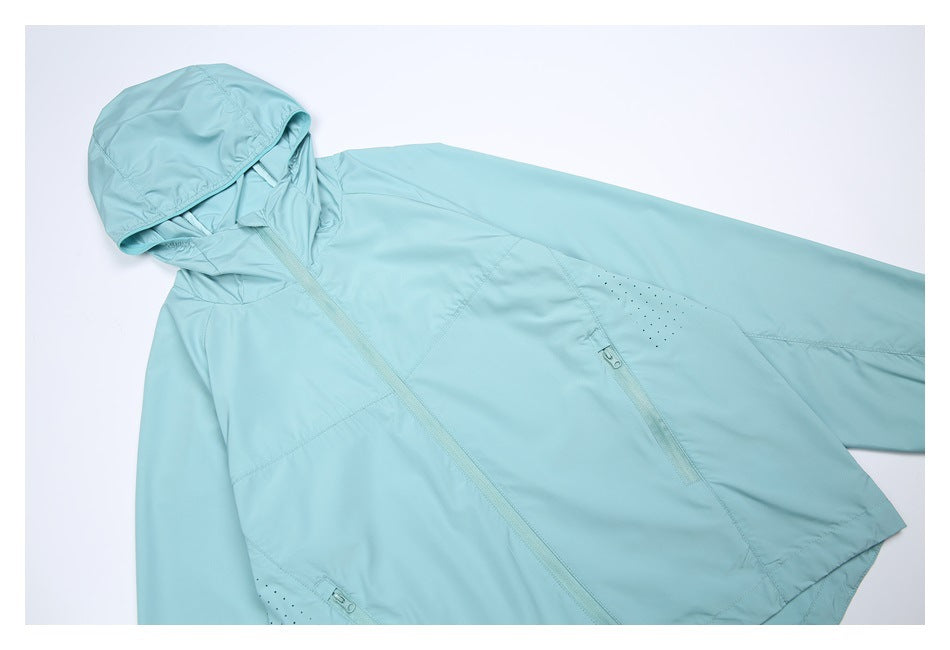 Angled front view of a light aqua hooded jacket, showing its full-length zipper, zip pockets, and perforated panels.
