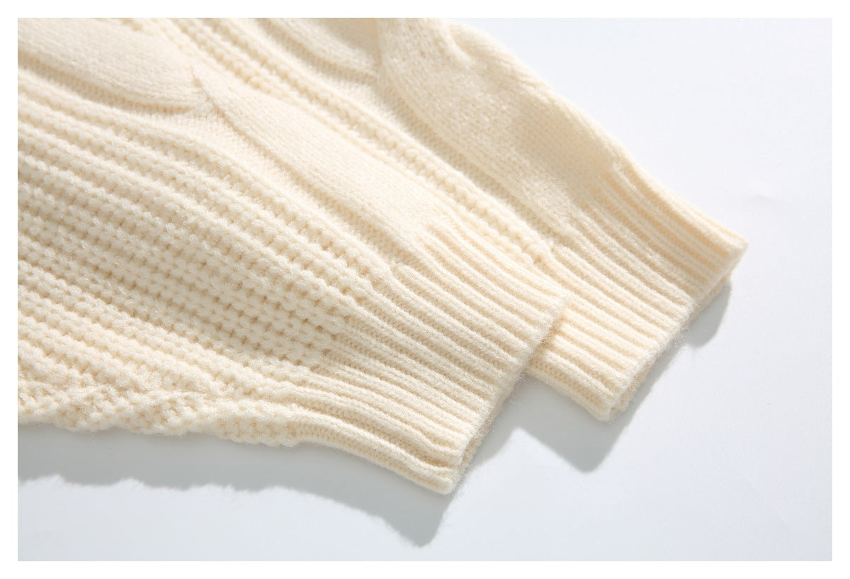 Close-up of the ivory cardigan's sleeves and ribbed cuffs against a white background.