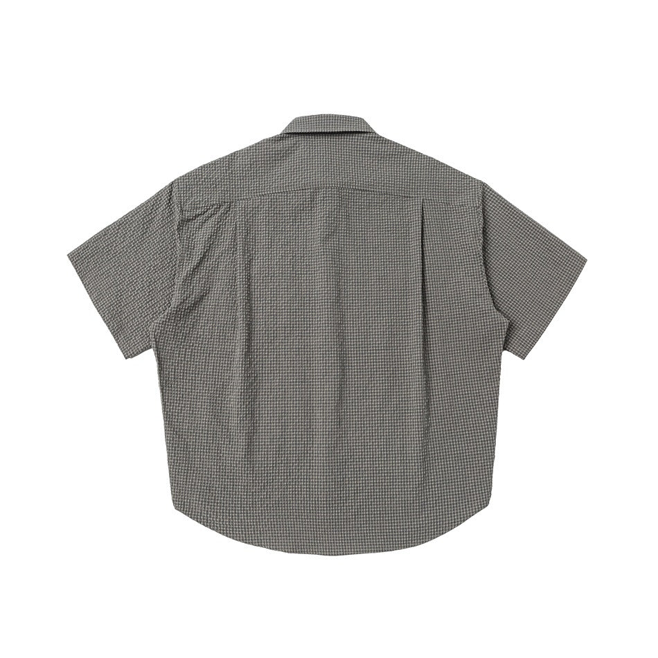 Back view of gray-green small-check short-sleeve shirt with back yoke seam, flat lay