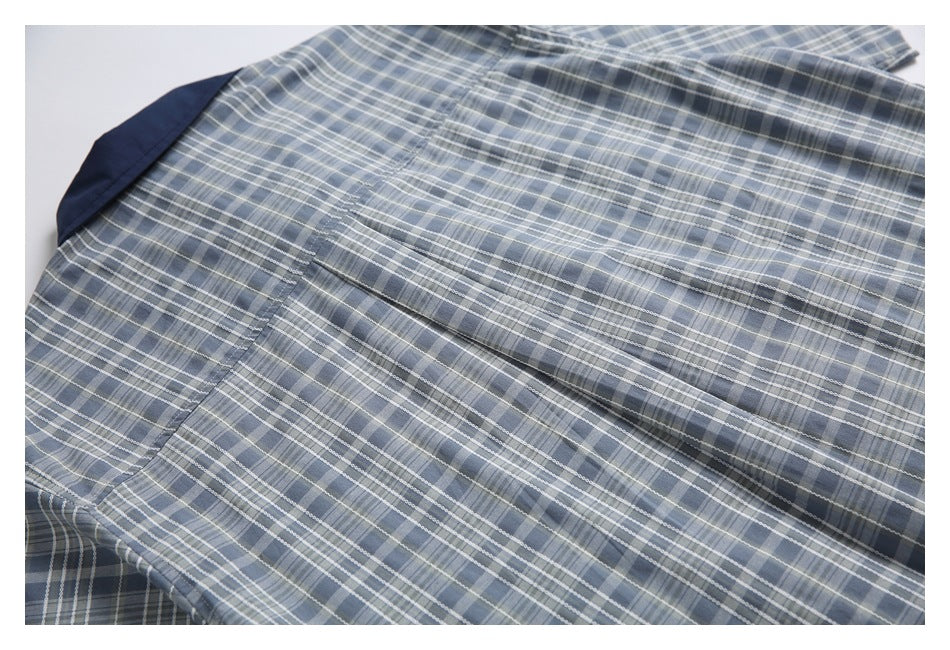 Close-up of the shirt's blue-gray plaid back yoke, seams, and center pleat.