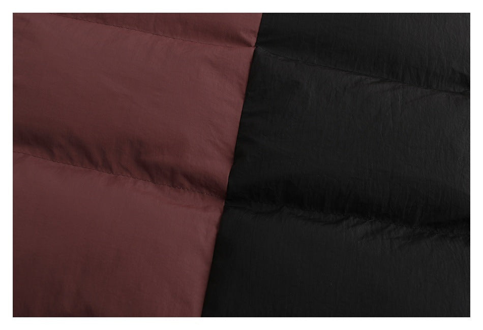 Close-up of the padded jacket's muted burgundy and black quilted panels.