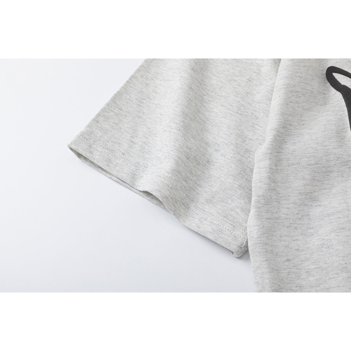 Close-up of the heather gray T-shirt's short sleeve and stitched hem.