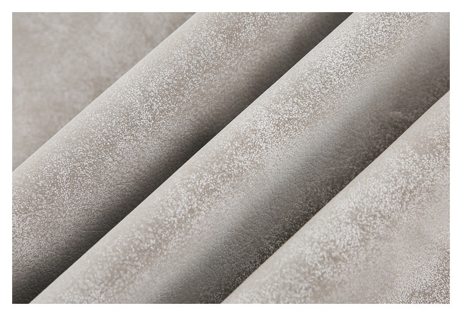 Close-up of the jacket's mottled taupe material arranged in soft folds.