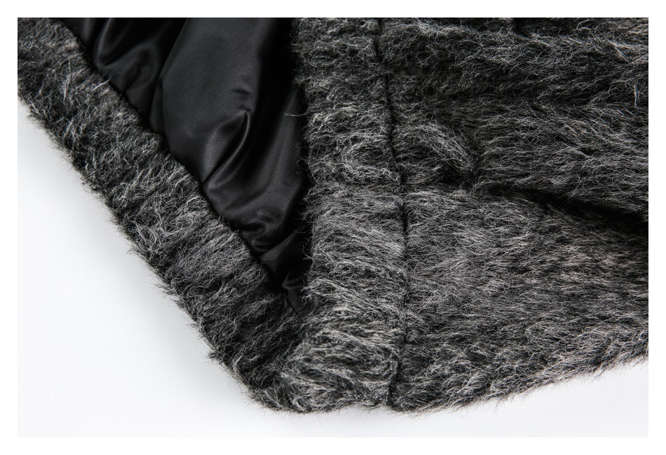 Close-up of the garment's black lining beside shaggy charcoal-gray fabric and a seam.