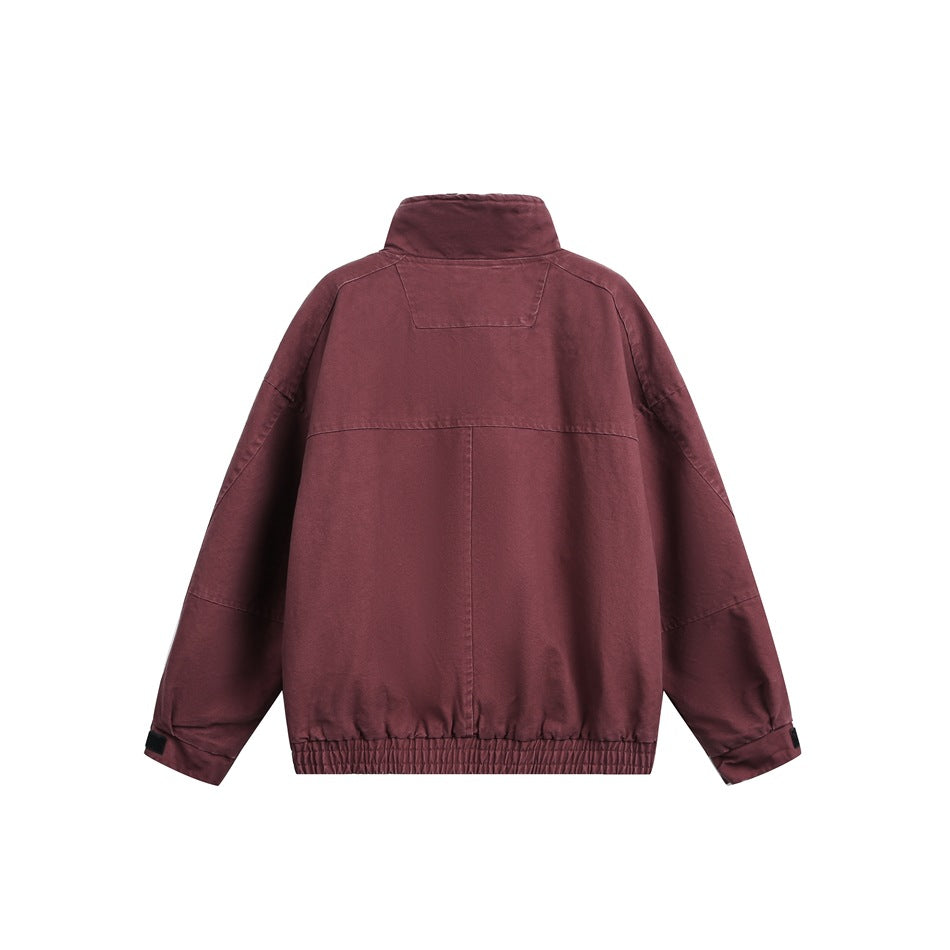 Back view of a burgundy stand-collar jacket with a panelled design and elastic hem.