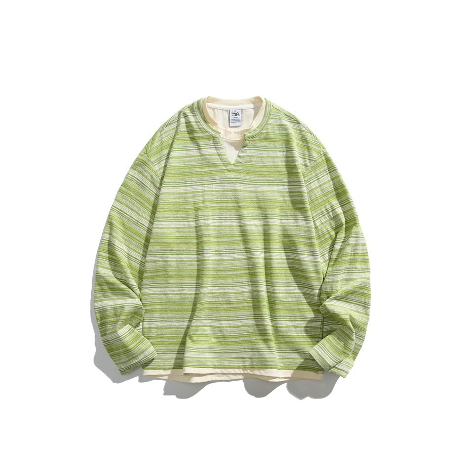 Green multicolor striped long-sleeve sweatshirt with notched V-neck and cream layered hem, flat lay