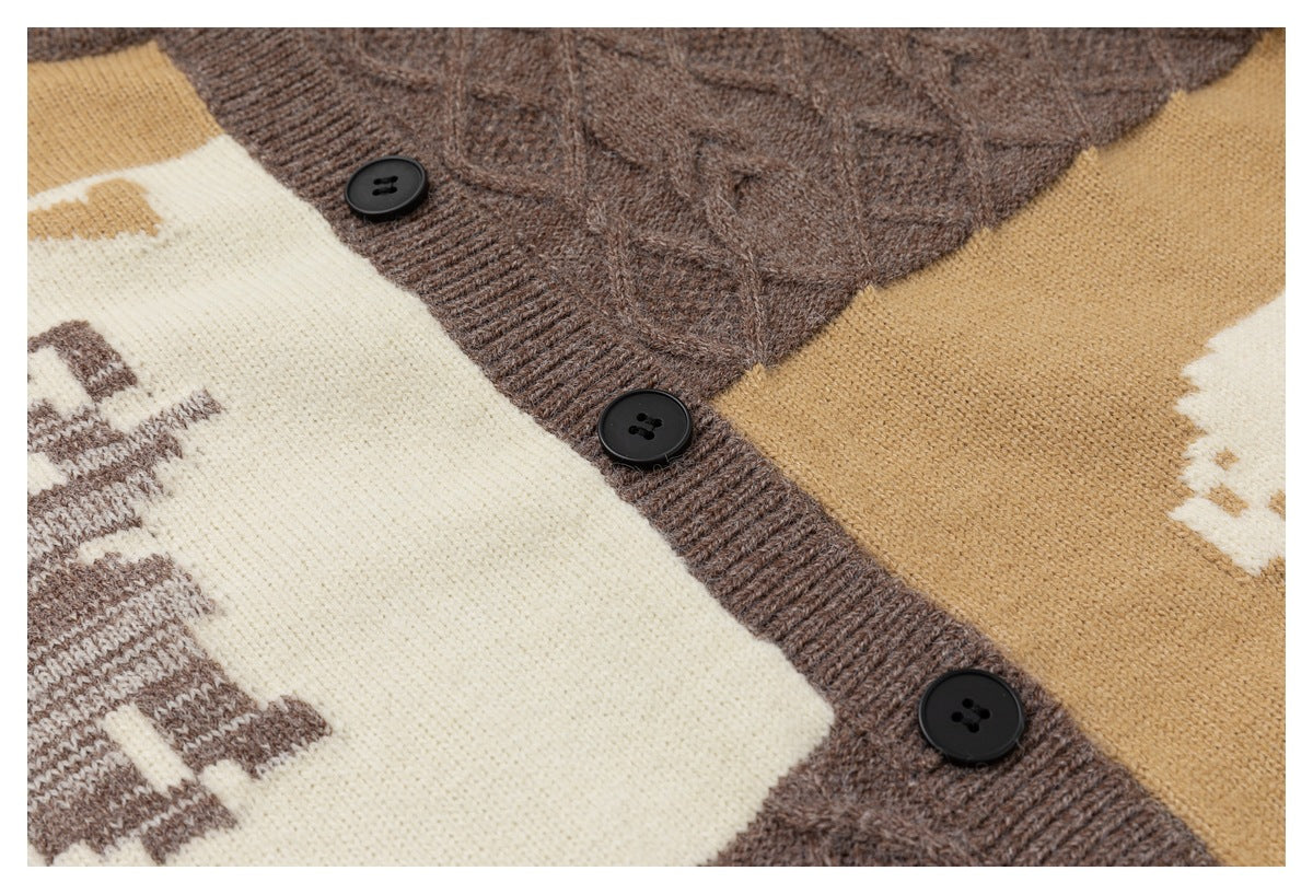 Close-up of three black buttons on the brown cardigan placket between ivory and camel knit panels.