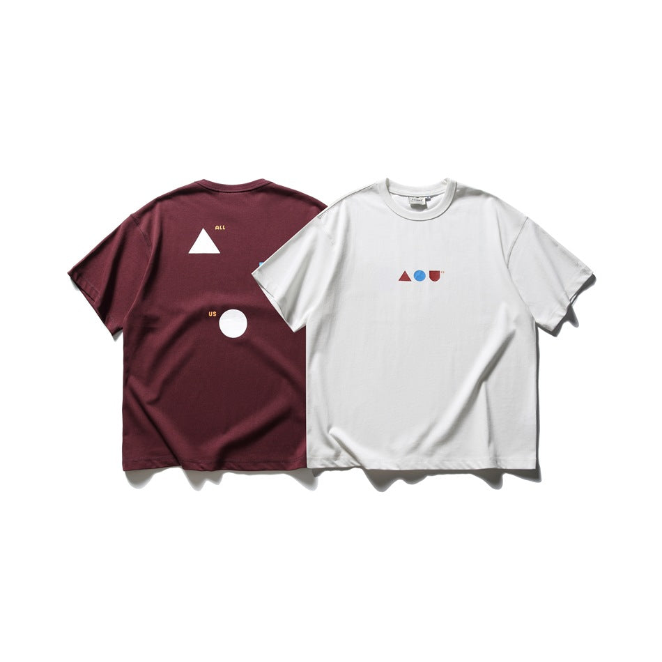White and burgundy T-shirts shown together, with small geometric chest graphics and larger graphics on the burgundy shirt's