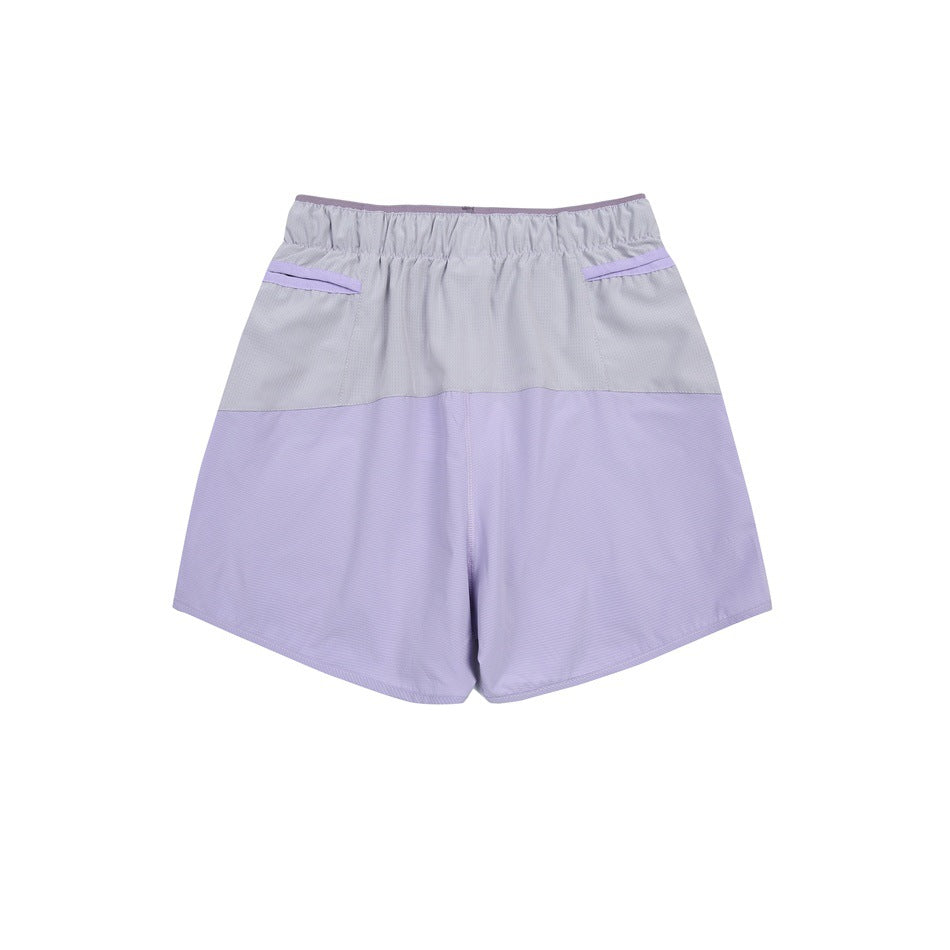 Rear view of lavender and pale gray color-block shorts with an elastic waistband and two back pockets.