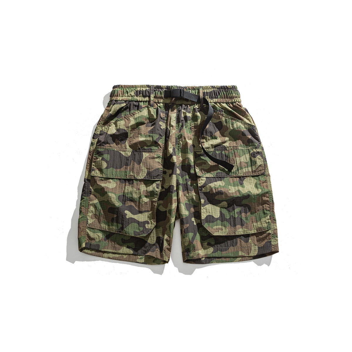 Camouflage cargo shorts flat lay with elastic waist, black buckle belt and large front flap pockets