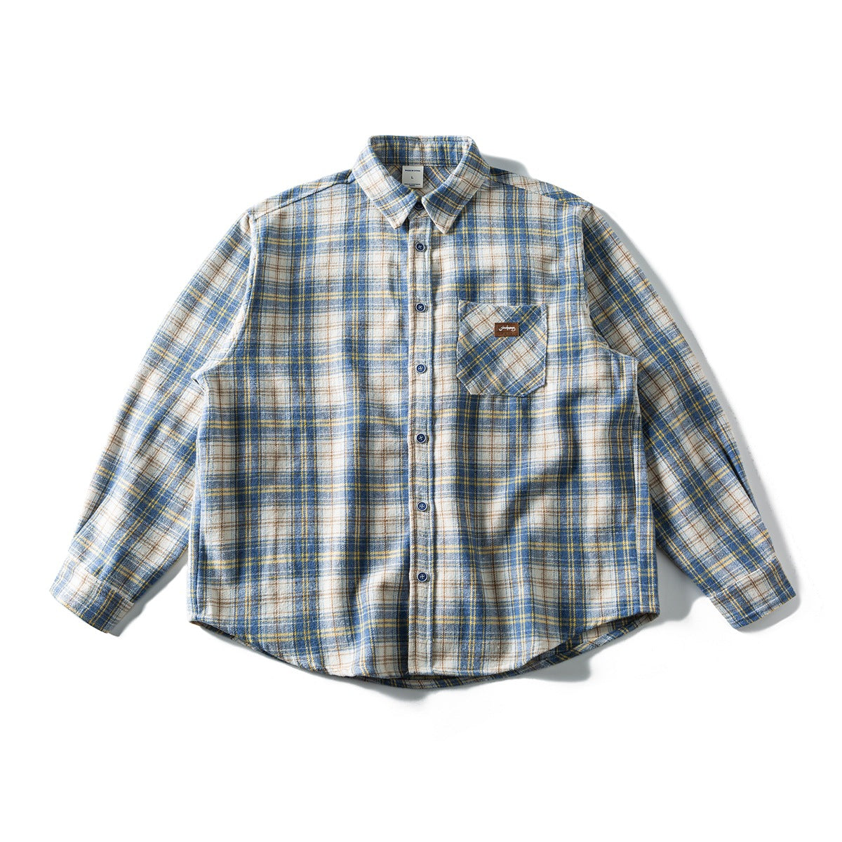 Blue and white plaid long-sleeve button-up shirt laid flat, with chest pocket and curved hem