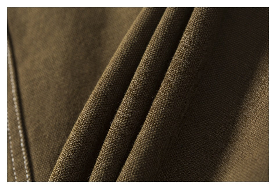 Close-up of brown jacket fabric folded to show its textured surface.