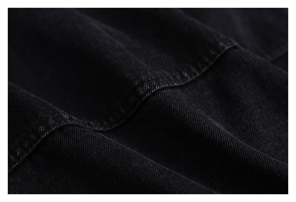 Close-up of black twill fabric and a curved stitched seam.