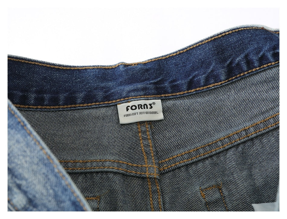 Close-up of the inside waistband showing a sewn brand label and denim stitching.