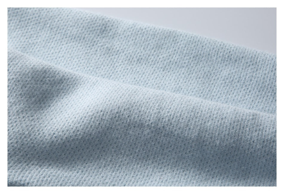 Close-up showing the fine knit texture of pale blue garment fabric.
