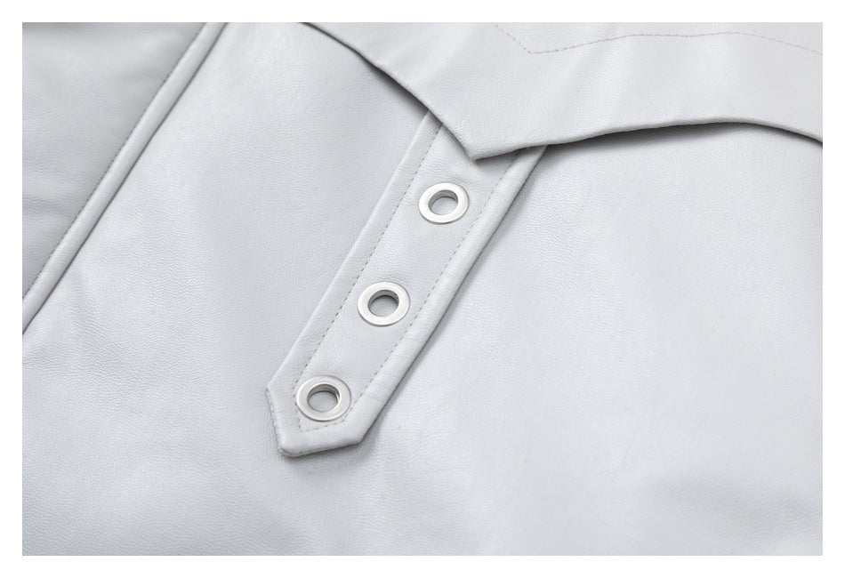 Close-up of three metal eyelets on a pale gray jacket placket.