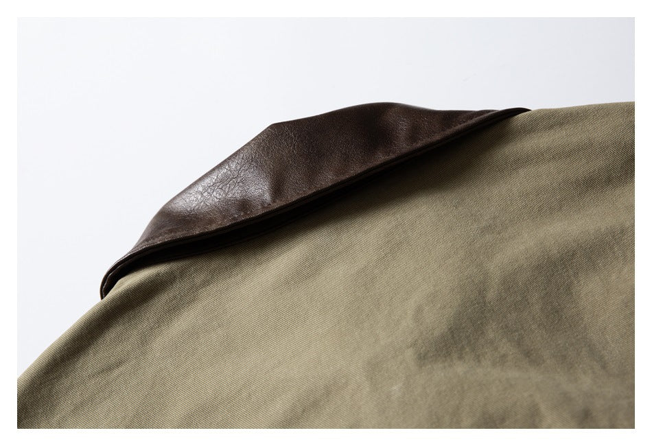 Close-up of a dark brown collar over olive-khaki garment fabric.