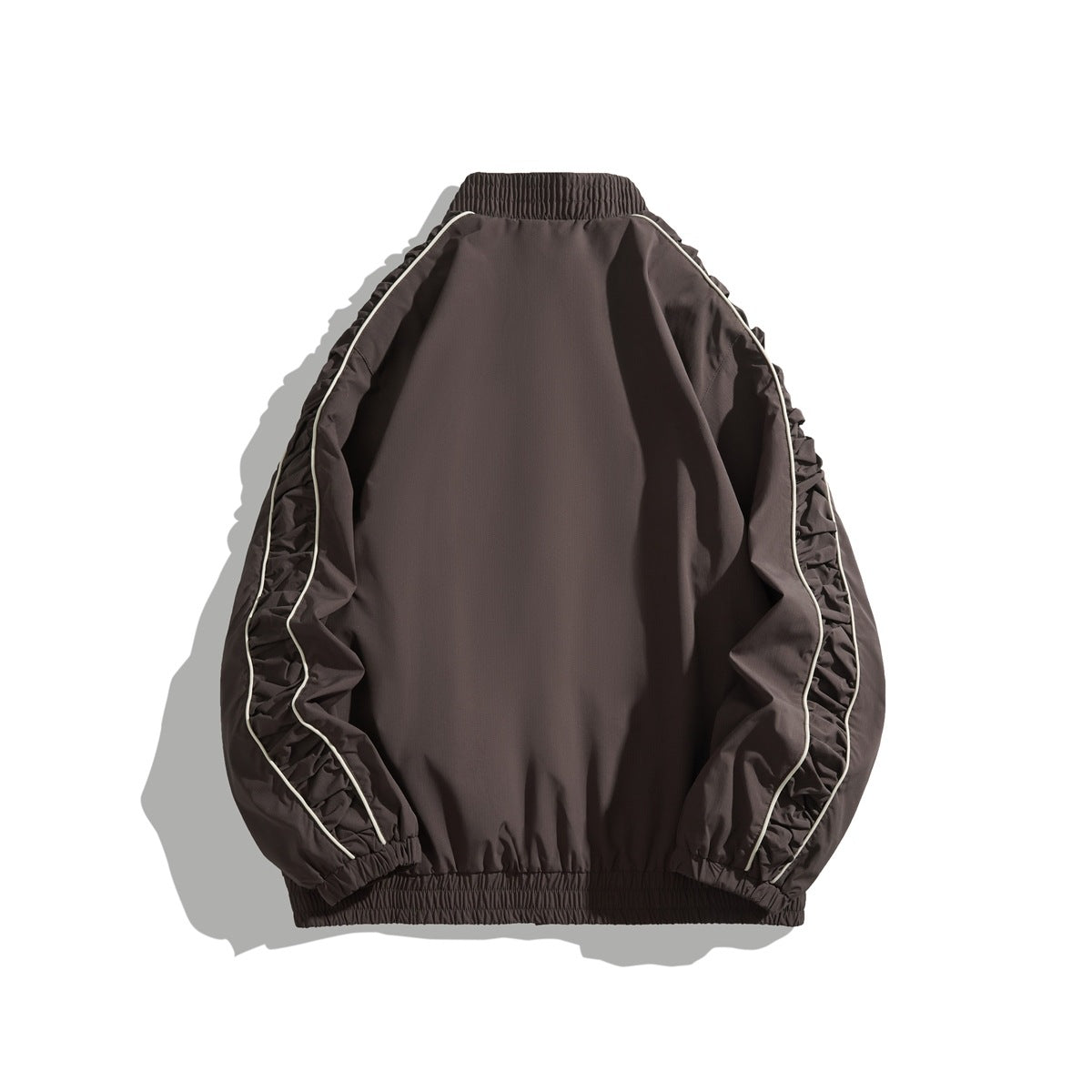 Back view of a dark brown jacket with gathered sleeves, elastic cuffs and hem, and light piping.