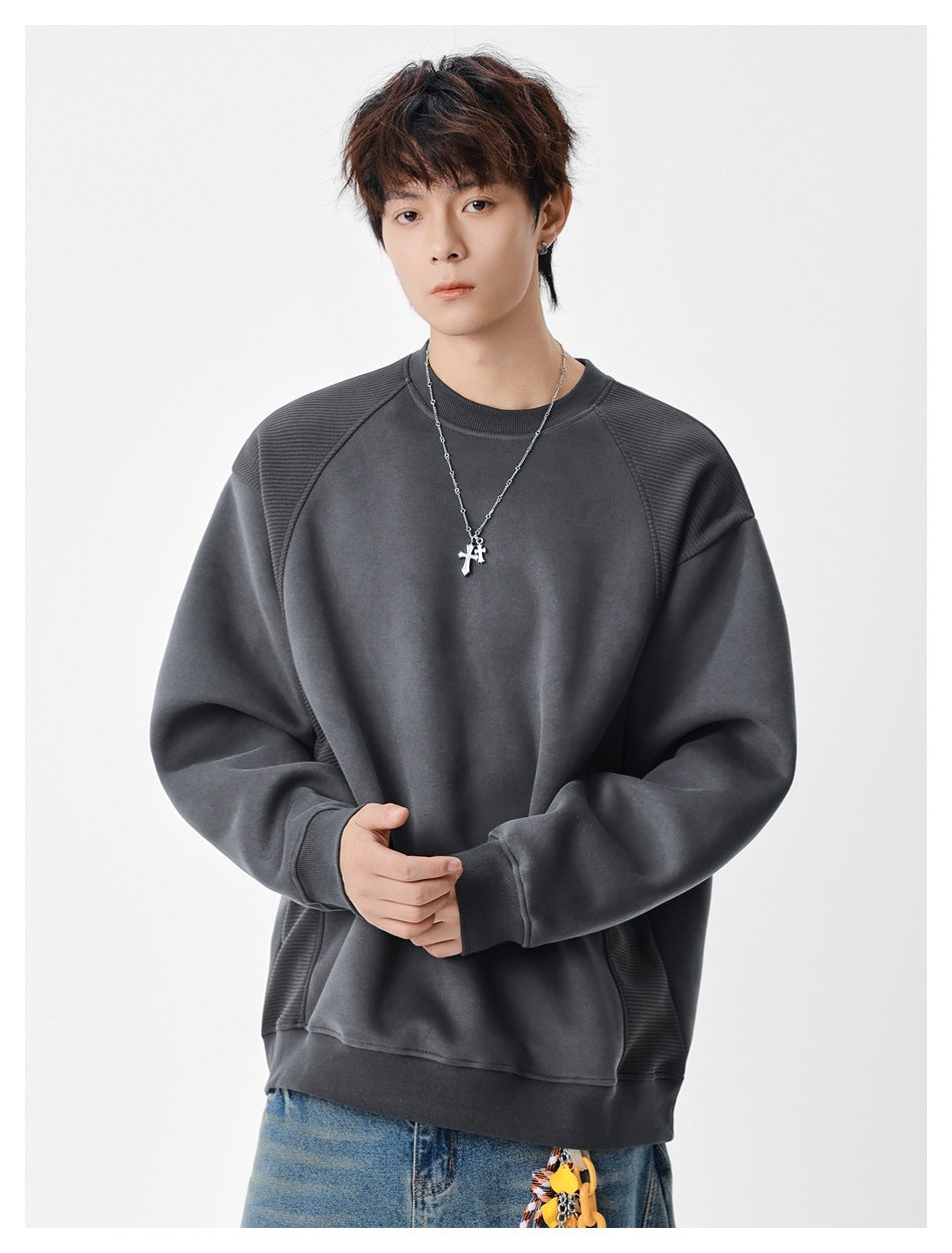 Model wearing a charcoal gray crewneck sweatshirt with ribbed textured shoulder and side panels.