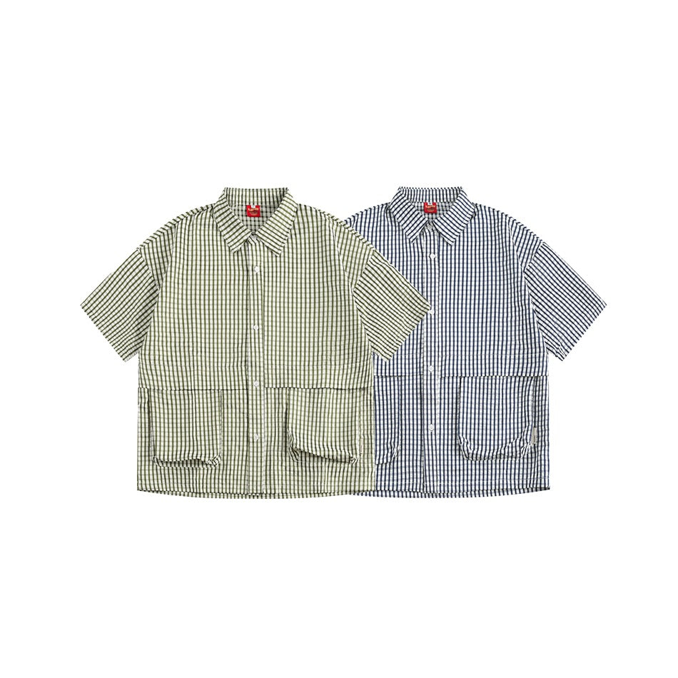 Two short-sleeve button-up shirts shown from the front in olive-and-white and navy-and-white checks.
