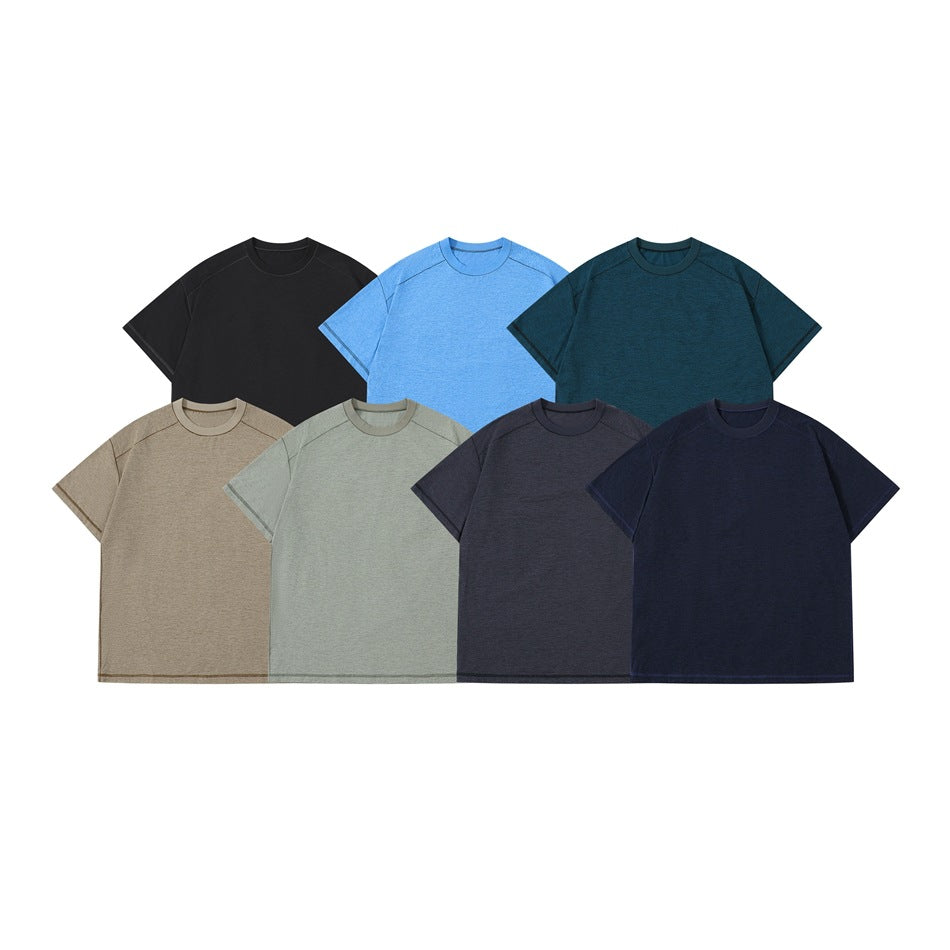Seven short-sleeve crew-neck T-shirts shown together in black, blue, teal, taupe, sage, charcoal, and navy.