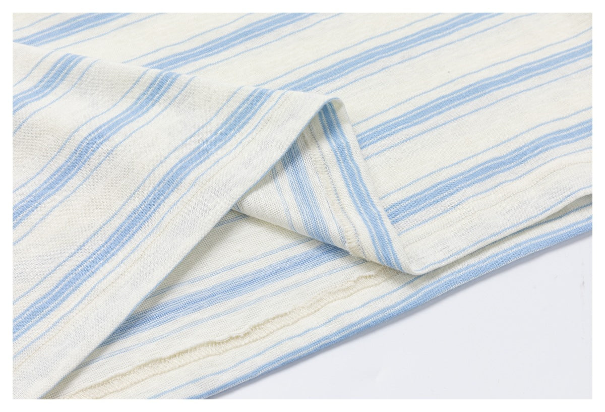 Close-up of striped off-white fabric folded back to show an interior seam.
