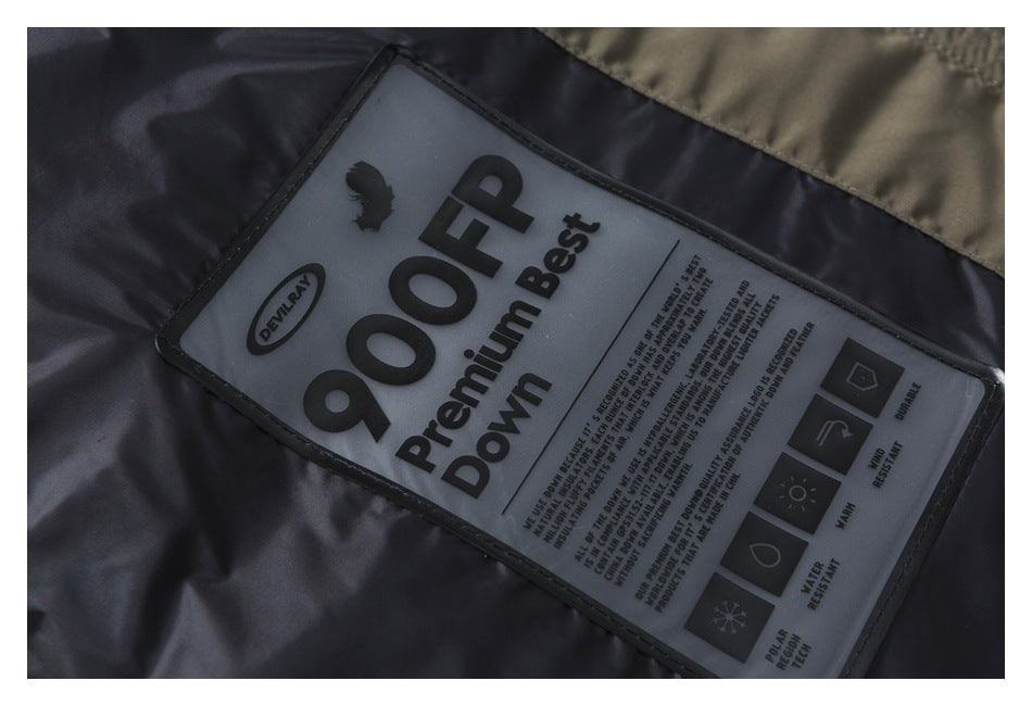 Close-up of a garment's dark lining and label marked “90% Premium Best Down,” with care symbols and text.