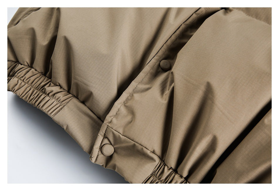 Close-up of beige padded garment with gathered elastic edging and a snap-fastened flap.