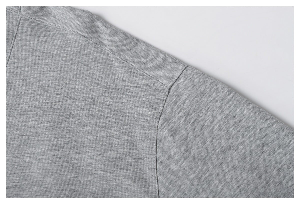Close-up of the heather gray top's shoulder seam and sleeve seam.