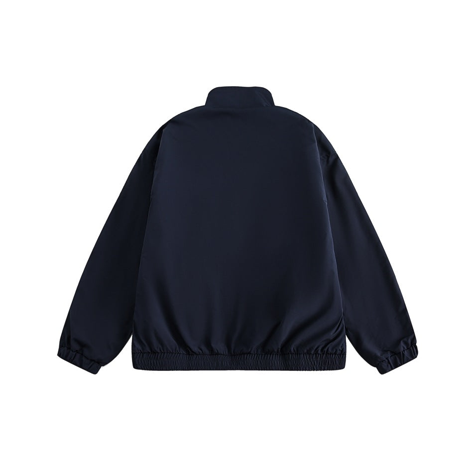 Back view of a plain dark navy zip jacket with a stand collar, elastic cuffs, and gathered hem.