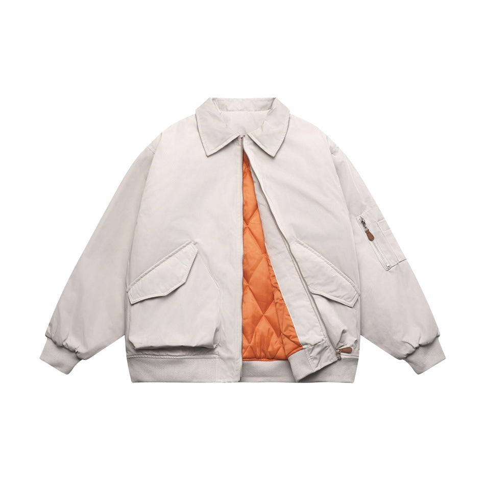 Light gray bomber jacket partly unzipped, showing orange diamond-quilted lining, flap pockets and sleeve zip pocket