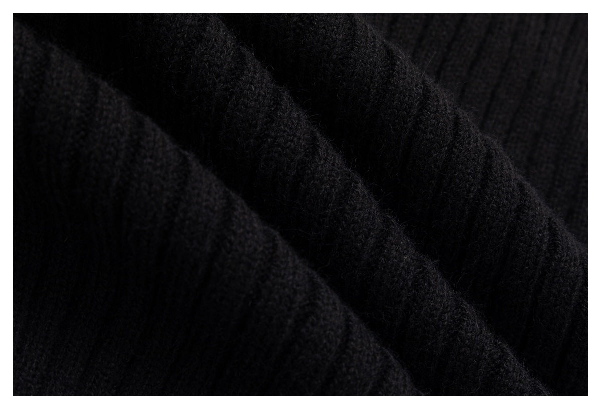 Extreme close-up showing the soft, textured knit stitches of a black garment.