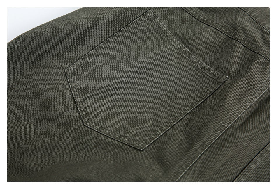 Close-up of an olive-gray trouser back pocket and visible stitching.
