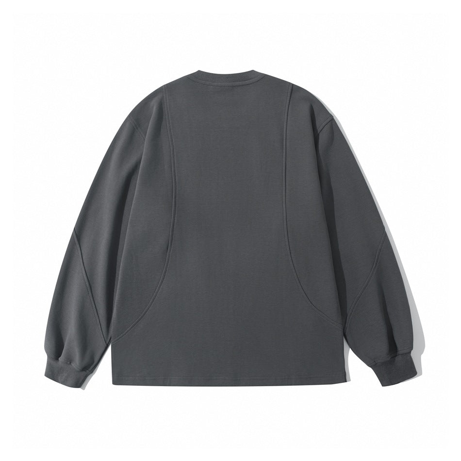 Back view of a charcoal gray long-sleeve crewneck sweatshirt with curved seam panels and ribbed cuffs.