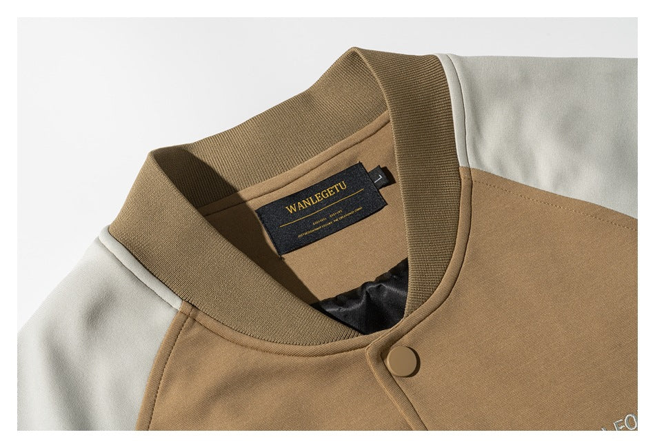 Close-up of the tan jacket's ribbed collar, cream sleeve, snap button, and inner neck label.