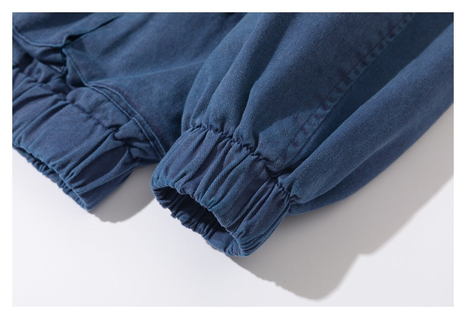 Close-up of gathered elastic cuffs on blue garment sleeves.