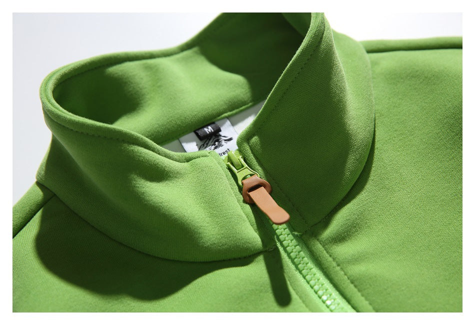 Close-up of the green pullover's stand collar and quarter zipper with a tan pull tab.