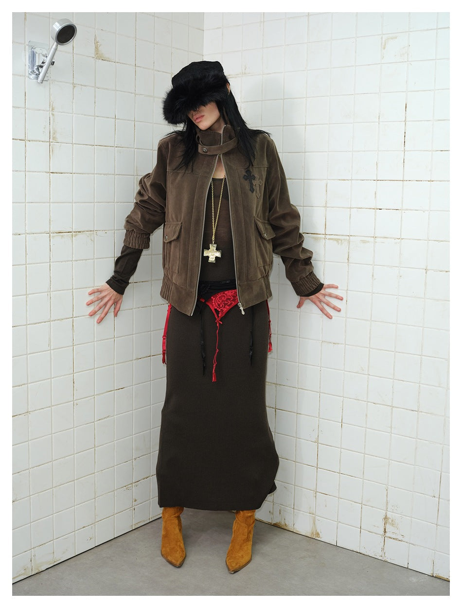 Full-length model wearing a dark brown jacket with a raised collar, front zipper, flap pockets and gathered cuffs.