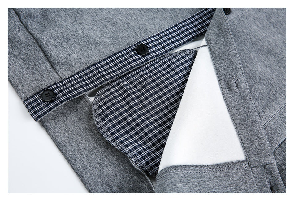 Close-up of the gray garment opened to show dark plaid inner facing, white lining, and black buttons.