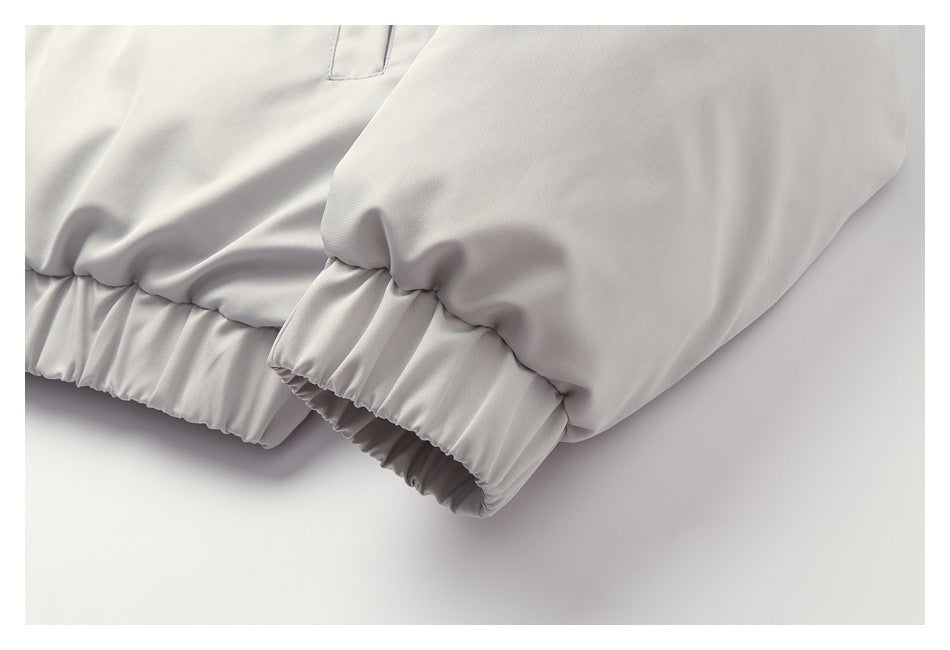 Close-up of the light gray jacket's sleeve ends and gathered elastic cuffs.