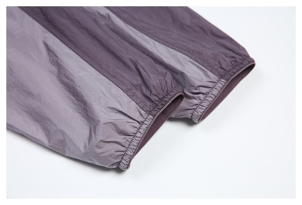 Close-up of the jacket's gathered elastic cuffs with dark purple trim.