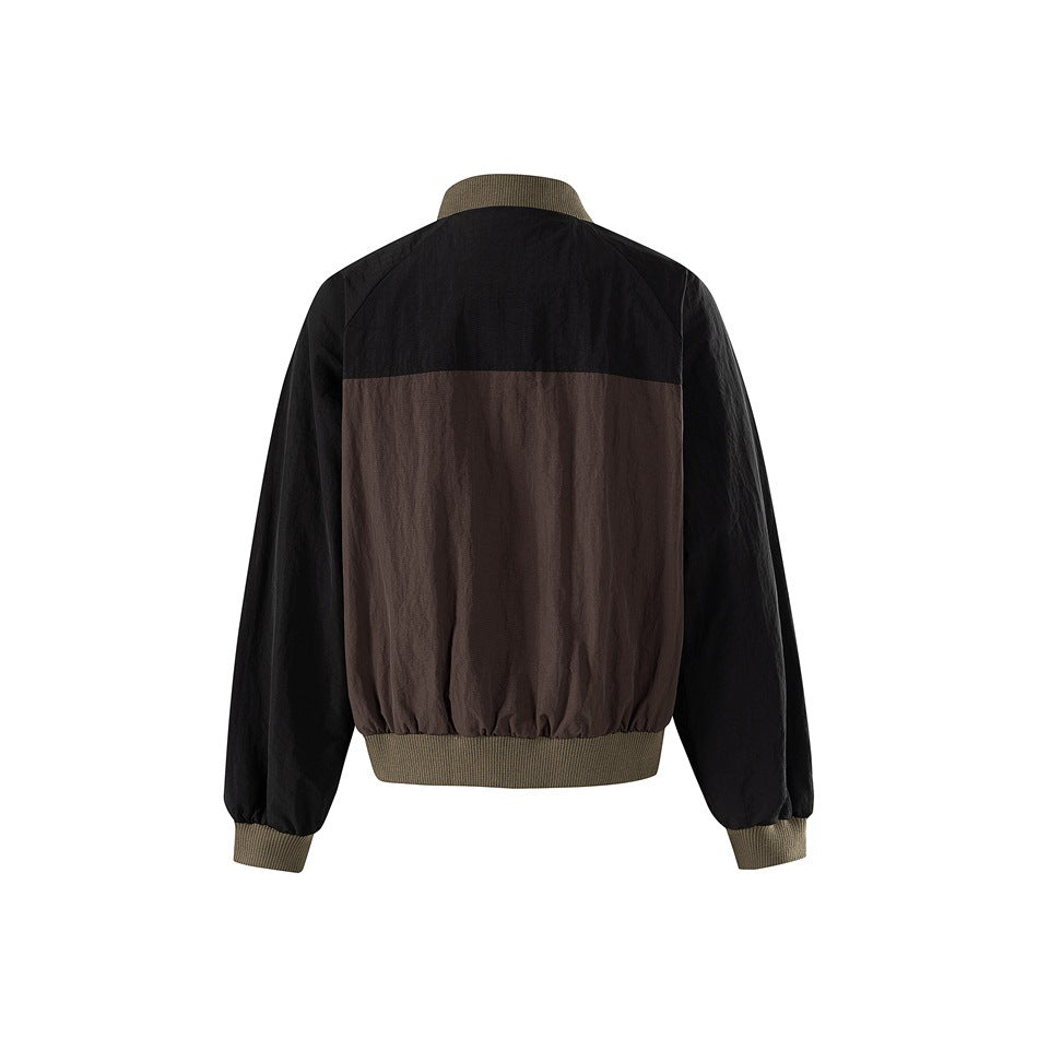 Back of brown and black bomber jacket with black upper yoke, brown lower panel and olive ribbed hem and cuffs