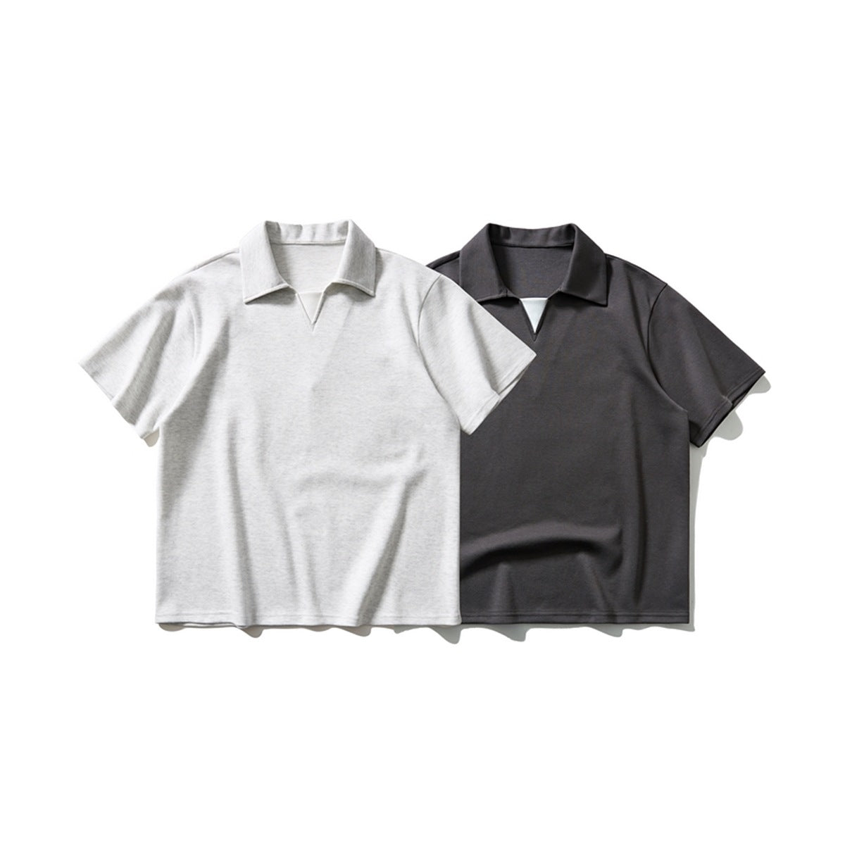 Two short-sleeve polo shirts with open V-necks, shown flat in light gray and charcoal.