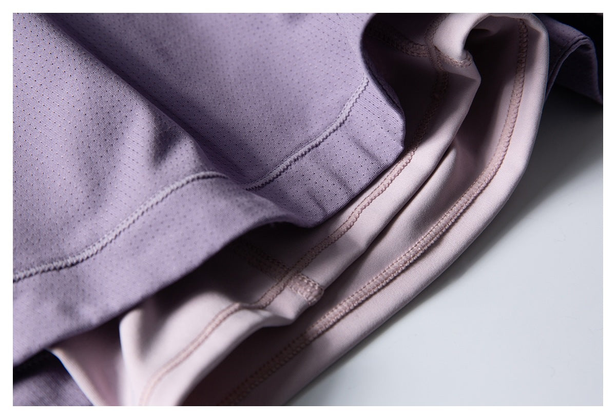 Inside view of lavender shorts showing the perforated fabric, pale lining, and stitched seams.