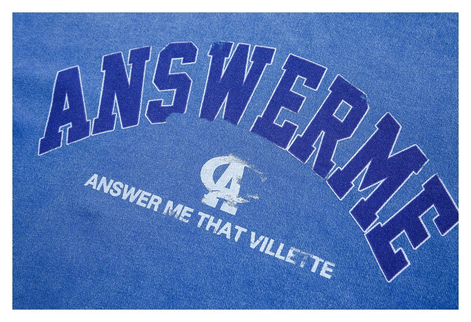 Close-up of a blue sweatshirt chest print with large outlined ANSWER ME lettering and smaller white text.